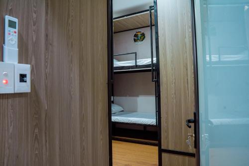a door to a room with a bunk bed at Savor Hostel-Motorbike Rental-Tour in Làng Lap