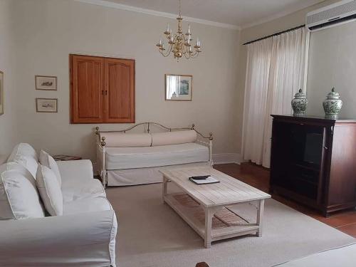 a living room with a couch and a coffee table at De Kothuize 18 in Graaff-Reinet