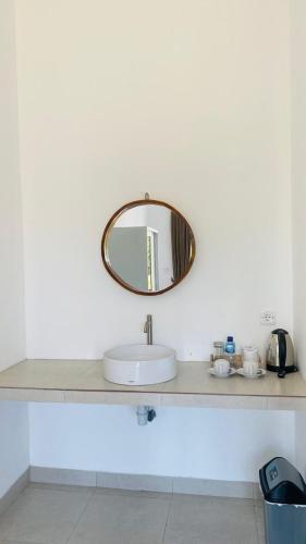 a bathroom sink with a mirror on a counter at Evara Hill Homestay in Uluwatu