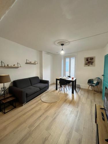 a living room with a couch and a table at Bleu Mandarou in Millau