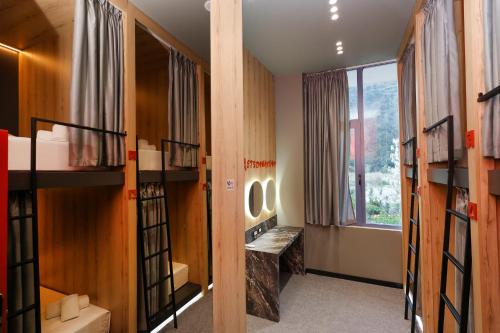 a room with bunk beds and a window at Grand Hostel Berat in Berat