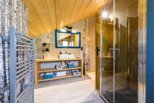 a bathroom with a sink and a shower at Le Chalet Milien in La Bresse