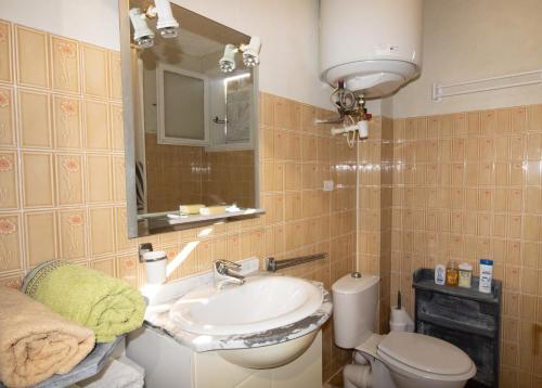 łazienka z umywalką, toaletą i lustrem w obiekcie Duplex w mieście Grosseto-Prugna