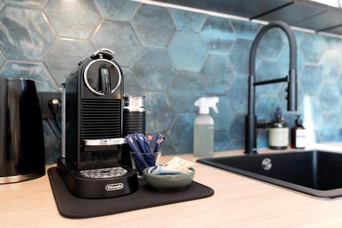 a coffee maker sitting on a counter next to a sink at Das Alte Pfarrhaus - Scheune in Gleisweiler