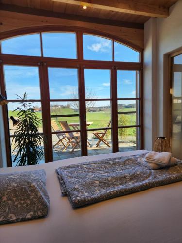 a bedroom with a bed with a large window at Ferienwohnung Polsing 19 in Palling