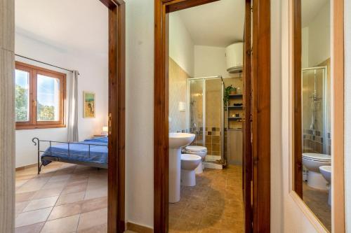 a bathroom with two toilets and a sink and a shower at Casa Nuages in Badesi