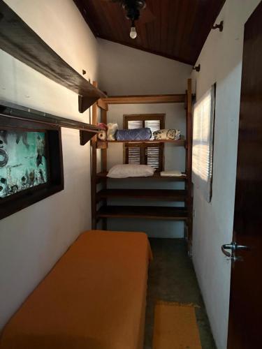 a small room with a bed and a small room with a bunk bed at Refúgio da Vila in Ilhabela
