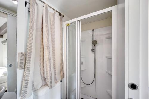 a bathroom with a shower and a shower curtain at Mobile Home Next 229 in Pietra Ligure