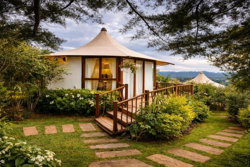 a small gazebo with a staircase leading to it at Hemma Genki Luxury Wellness Hotel Villa in Villa de Leyva