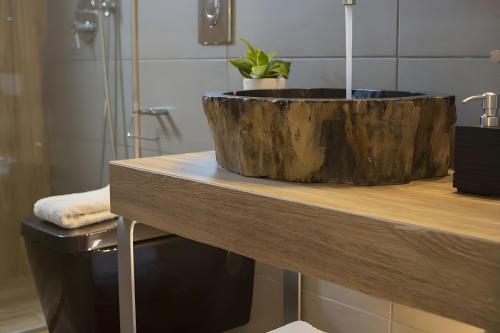a wooden tub sitting on top of a counter in a bathroom at Modern Country Villa in Lefkada