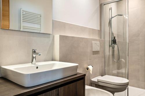 a bathroom with a sink and a toilet at Mountain Meadows Apt 3 in Valdaora