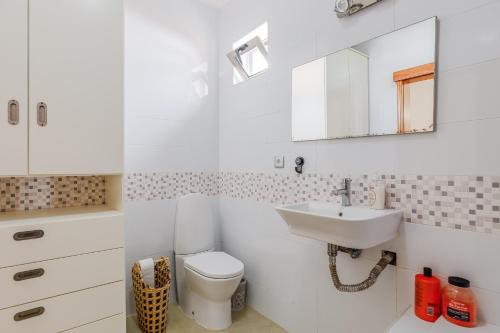 a white bathroom with a sink and a toilet at Vista Das Estrelas M4 - Terceira in Praia da Vitória
