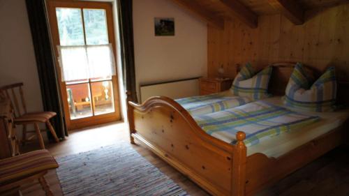 a bedroom with a large wooden bed in a room at Ferienwohnung Kramerblick in Grainau