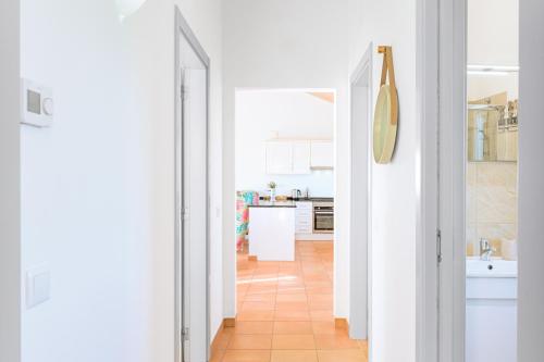 a kitchen with white walls and a tile floor at Paraiso da Serva - Courela da Serva in Odemira