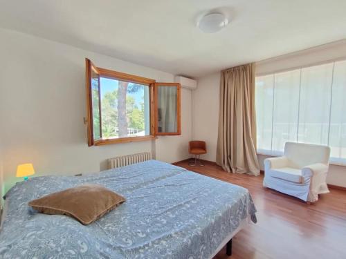 a bedroom with a bed and a chair and a window at Villa Vittorio a 4km dal mare in Trebbiantico