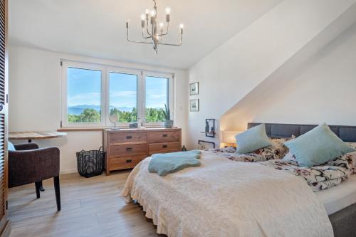 a bedroom with a bed and a sink and a window at Pfänderblick in Lindau