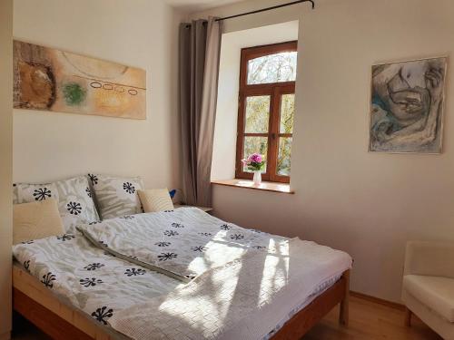 a bedroom with a bed and a window at Schöne Wohnung Landhaus-Flair in Aachen