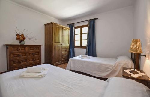 a bedroom with two beds and a window at Tonina in Pollença