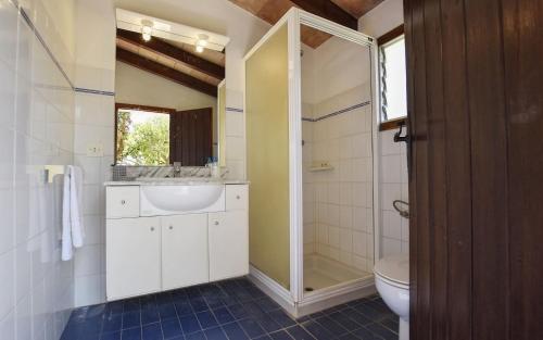 a bathroom with a shower and a sink and a toilet at Tonina in Pollença