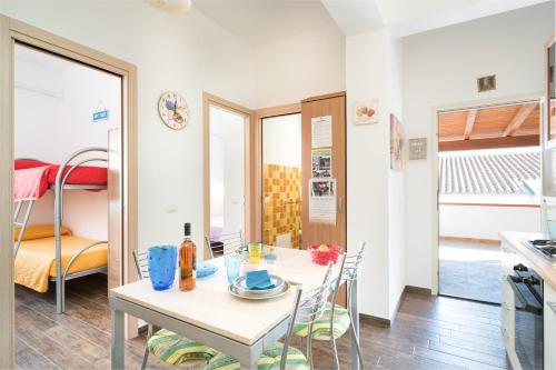 a kitchen and dining room with a table and chairs at Holiday vista mare in Cala Gonone