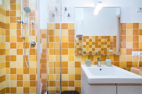 a bathroom with a sink and a shower at Holiday vista mare in Cala Gonone