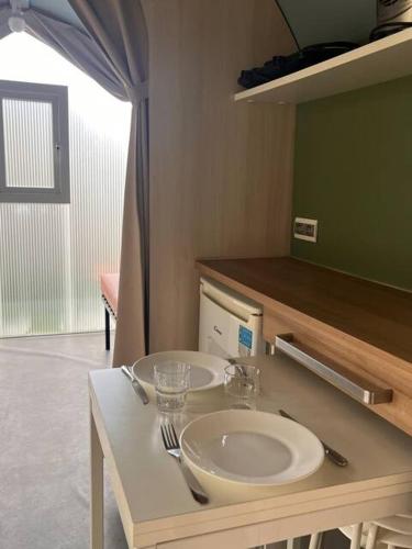 a bathroom with a sink and a mirror at Camping Arquebuse in Auxonne