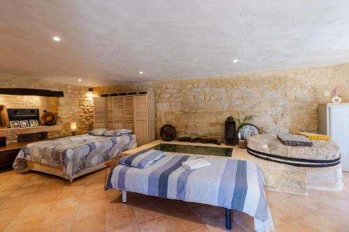 a bedroom with two beds and a swimming pool at Moulin au coeur de la nature in Thonac