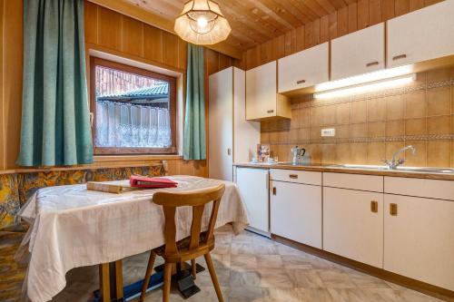 a kitchen with a table and a sink at Mittermüllerhof Feldthurns in Velturno