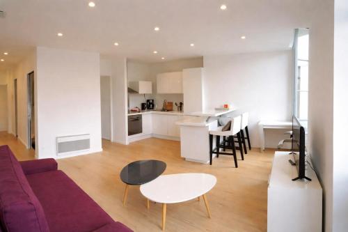 a living room with a couch and a table at Logement entier rue Sainte Catherine in Bordeaux