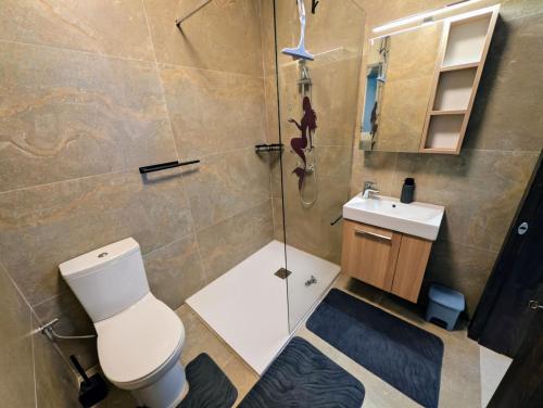a bathroom with a toilet and a sink and a shower at 19 Oaks in Marsaskala