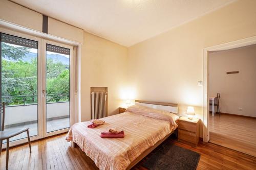 a bedroom with a bed and a large window at Residence Hubertus Ap 1 - Meran in Merano