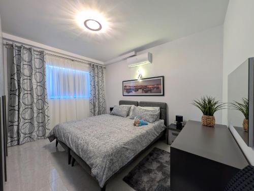 a bedroom with a bed and a window at 19 Oaks in Marsaskala