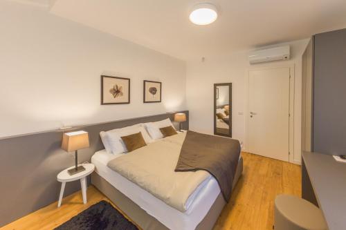a bedroom with a bed and a table with a lamp at Villa Minerva in Lazise