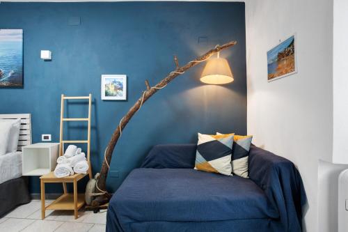 a bedroom with a bed with a tree branch on the wall at Ca Du Grifun 2 in Vernazza