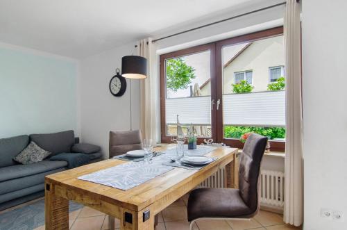 a dining room with a wooden table and chairs at Ferienwohnung mit Terrasse in Salem