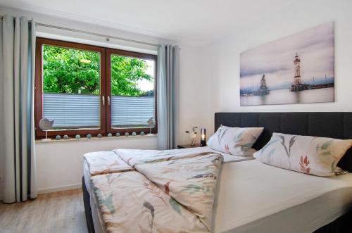 a bedroom with a bed and a large window at Ferienwohnung mit Terrasse in Salem