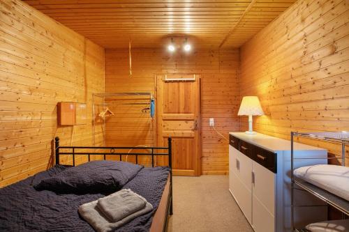 a bedroom with a bunk bed in a wooden room at Holzhaus Grimm in Fedderingen