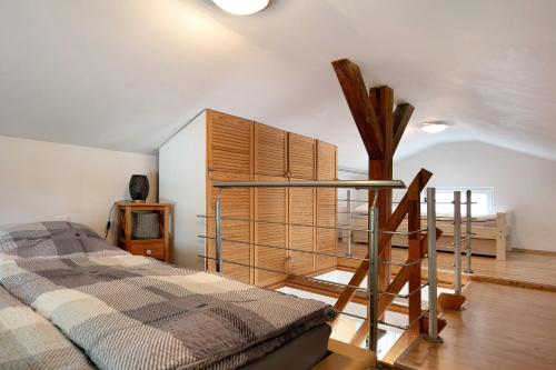 a bedroom with a bed and a wooden cabinet at Ferienhäuschen am See in Bestensee