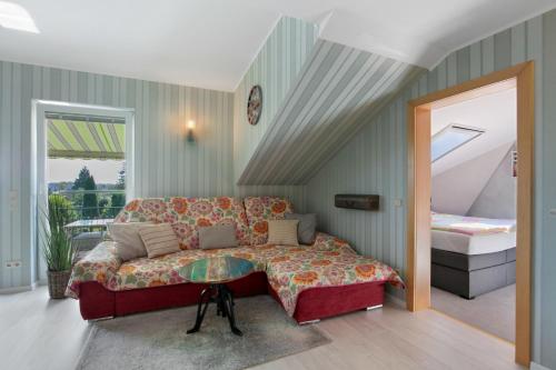 a bedroom with a couch and a bed in a room at Ferienhaus Jasmin in Neuruppin