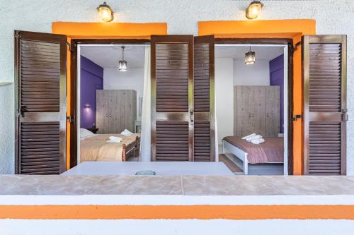 a bedroom with two beds and a room with two beds at Maltas studios in Corfu