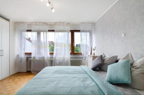 a bedroom with a large bed and a window at Ferienwohnung Marie in Niedereschach