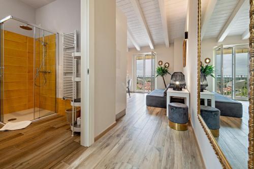 a large bathroom with a shower and a bedroom at Cavalino Boutique 2 in Cavaion Veronese