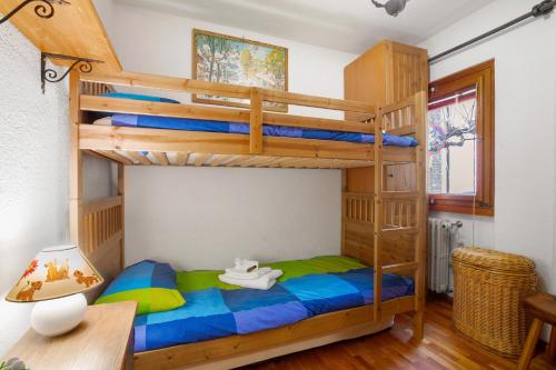 a bunk bed in a room with a desk at Courmayeur 3V21 in Courmayeur