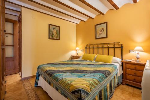 a bedroom with a bed and a wooden floor at Albahaca in Hinojares