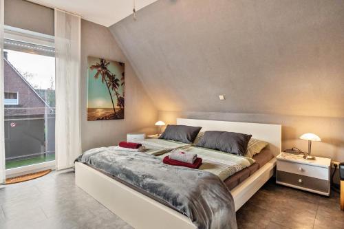 a bedroom with a large bed and a large window at Münsterland Stadtlohn in Stadtlohn