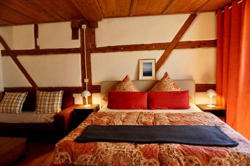 a bedroom with a large bed with red pillows at Inselgasse in Konstanz