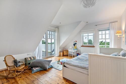 a bedroom with white walls and a bed in a room at Tine und Claras Ferienhaus in Ringsberg