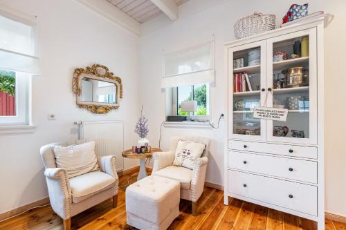 a living room with two chairs and a dresser at Tine und Claras Ferienhaus in Ringsberg