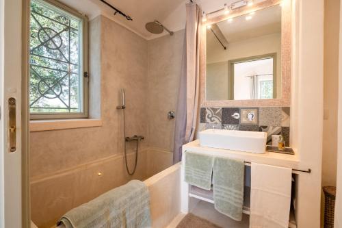 a bathroom with a sink and a shower at Trullo Nostress with pool in Ceglie Messapica