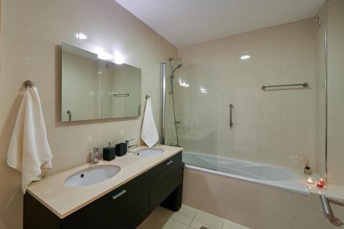 a bathroom with a sink and a shower and a tub at Penthouse Monte da Eira - Sunset in Albufeira